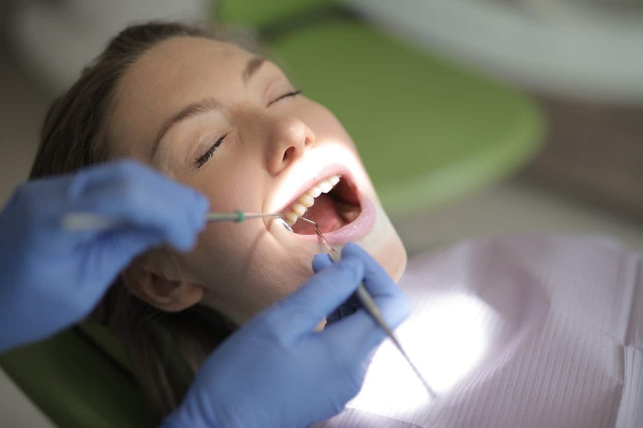 Woman having her mouth examined by a dentist.