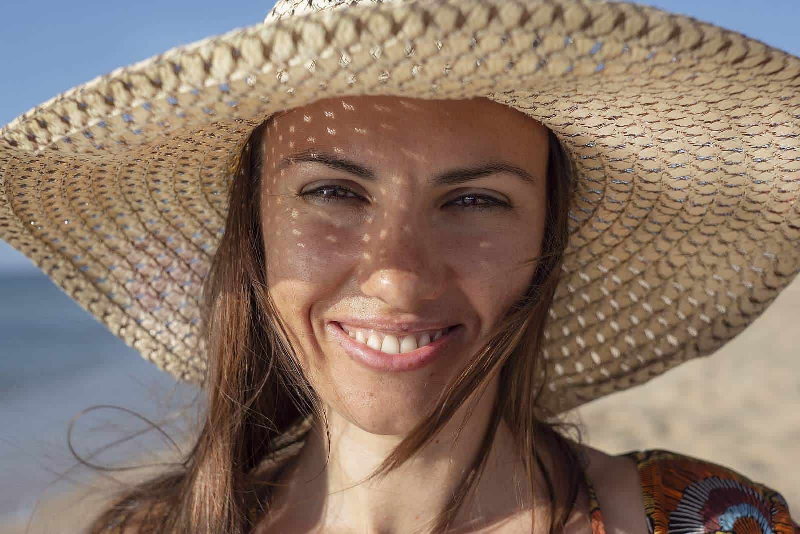 Woman in a sunhat smiling.