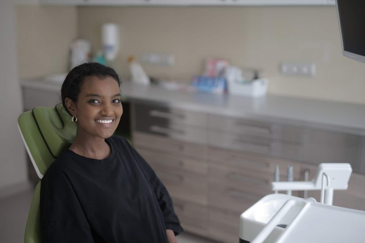 Smiling woman sitting in a dental chair.