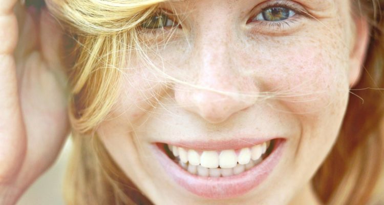 Close-up of a woman's smiling face.