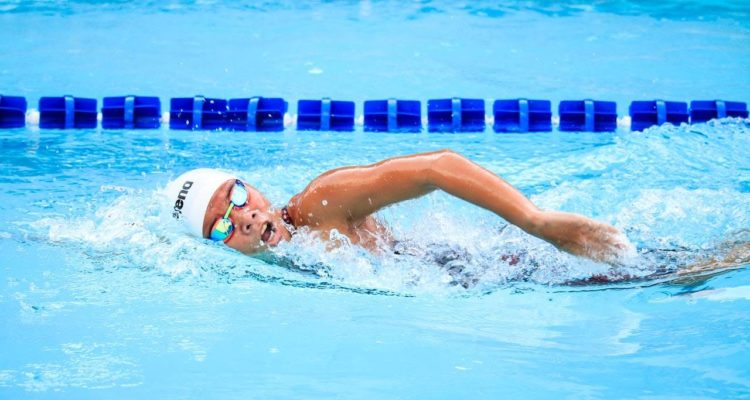 A person swimming in a pool.