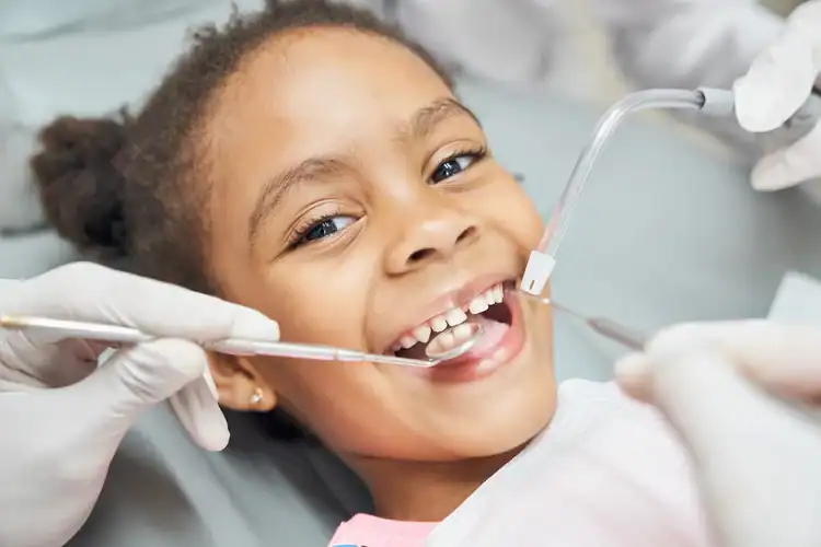 A picture of a girl getting her teeth checked