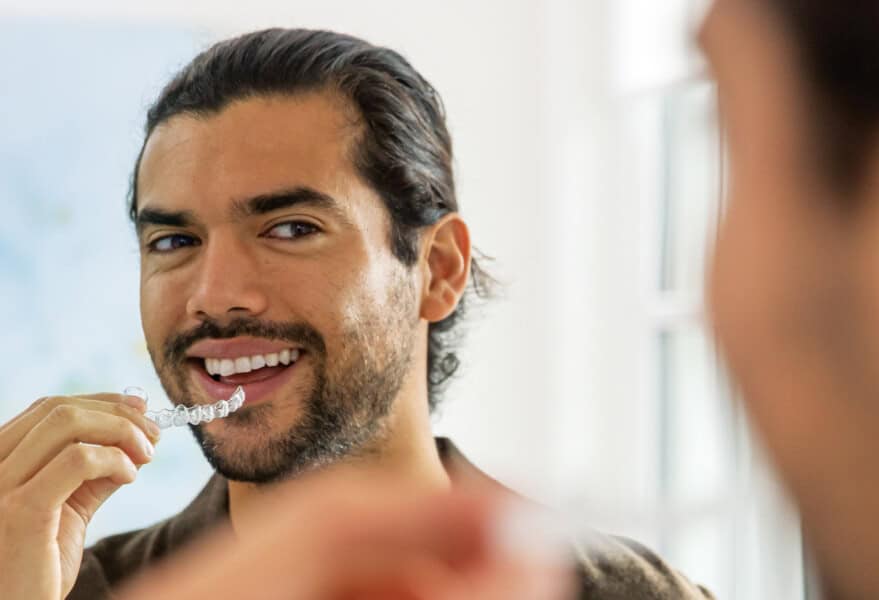 An adult in his 30s wearing Invisalign