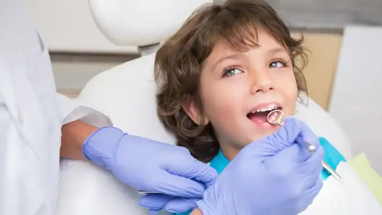 A picture of a child getting his teeth checked